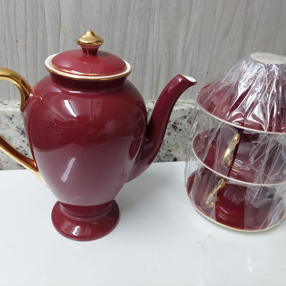 Steubenville Maroon Teapot w/Gold trim 8” tall. With 3 Demitasse Cups and Saucer